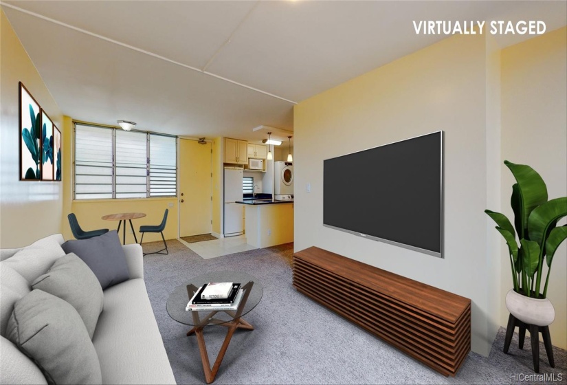 Virtually Staged - Looking back towards the front door and kitchen from the living room window. The area just off the kitchen to the left is a great space for a dining table or home office. The jalousie windows provide natural light and cool breezes.