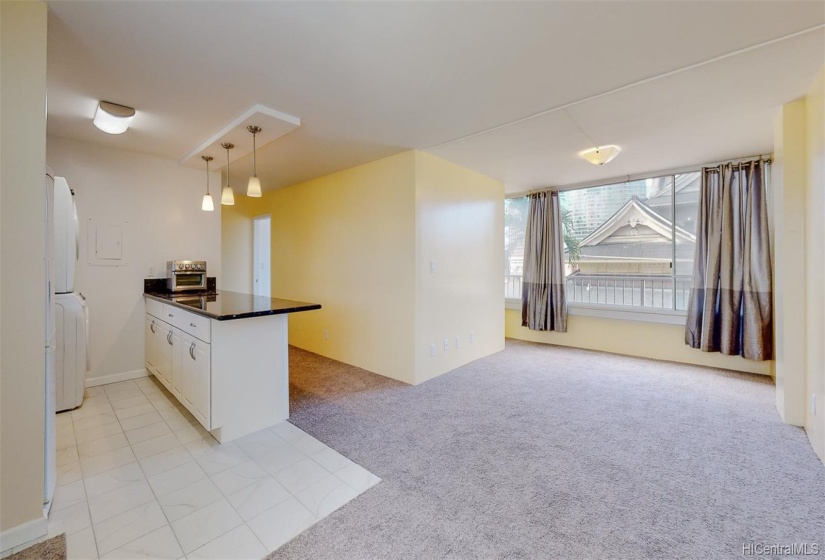 Open floor plan with large kitchen and bright spacious living room.