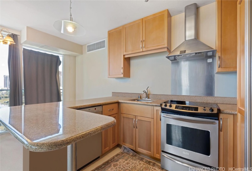 Enhanced. Kitchen with stainless steel appliances.