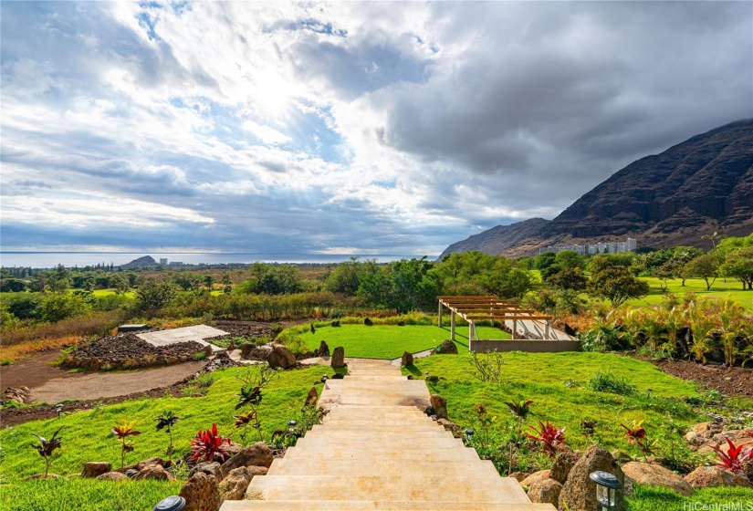 Multi-functional lower yard features a Garden Pavilion with trellis and a large platform (left) that can be used a stage, meditation/yoga area, dance floor & more