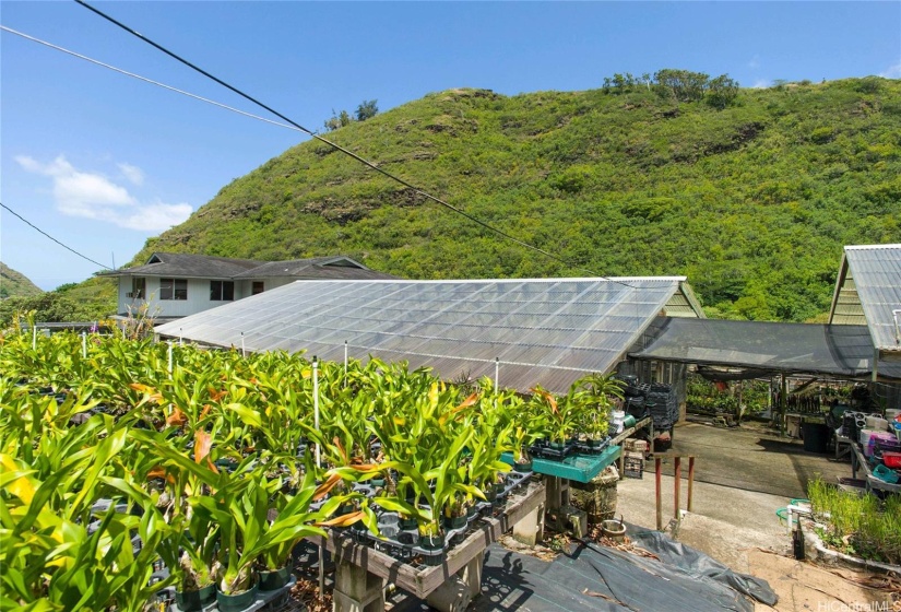 The covered structure in the foreground is the retail shop; the workshop is on the left. The hillside in the background is preservation land that makes up part of this property.