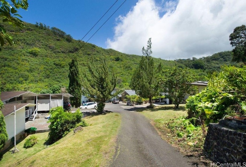 The driveway entry from Waiomao Road. There are three structures on the property, including two houses and one workshop.