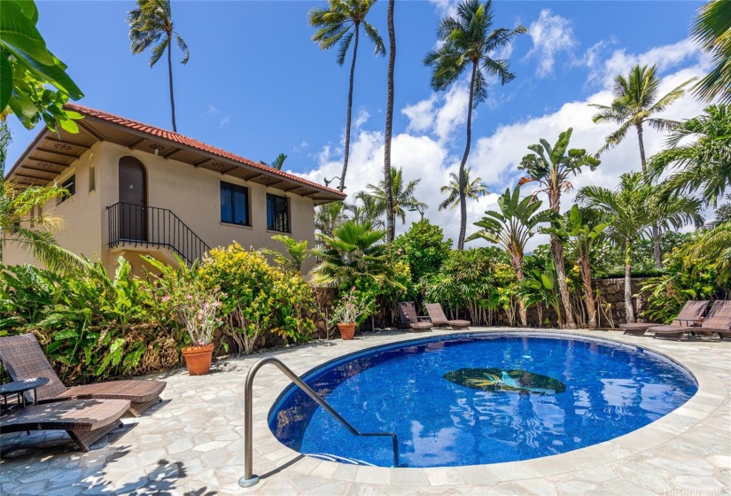 Gated, landscaped pool area with heated saltwater pool, recently re-tiled with bird of paradise design.