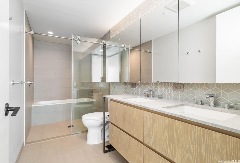 Master Bathroom features dual sinks and standing shower/bathtub combo.