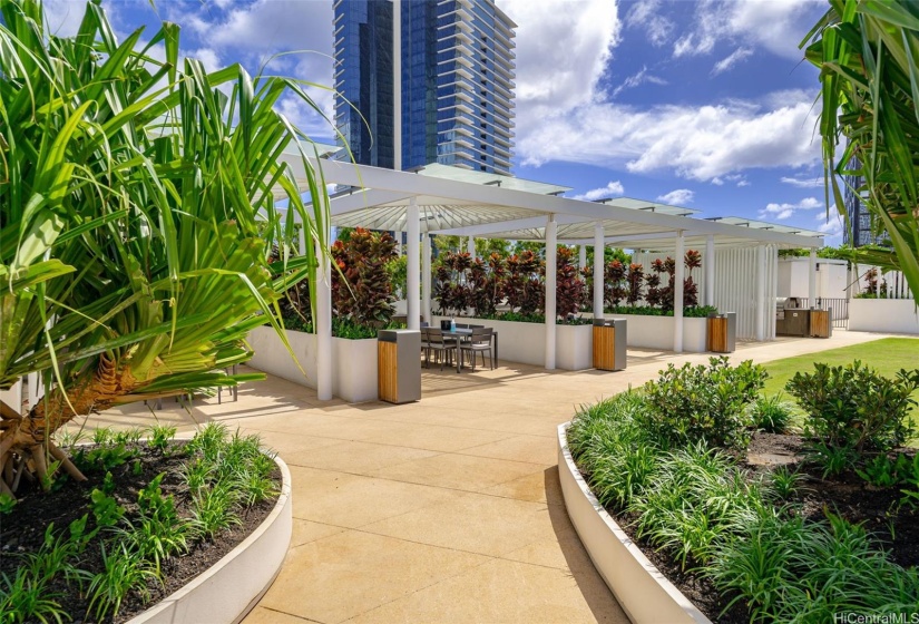 Lush landscaping fills the recreation deck bbq area.