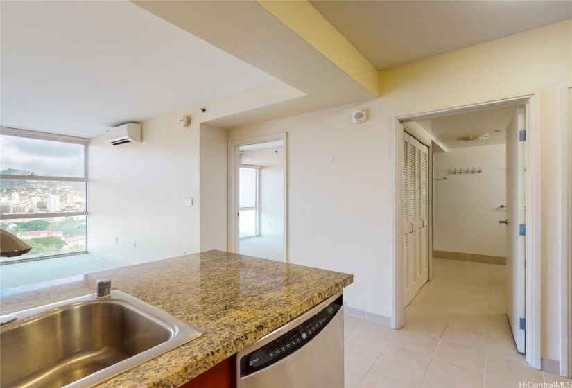 Looking from the kitchen into the bedroom and bathroom.