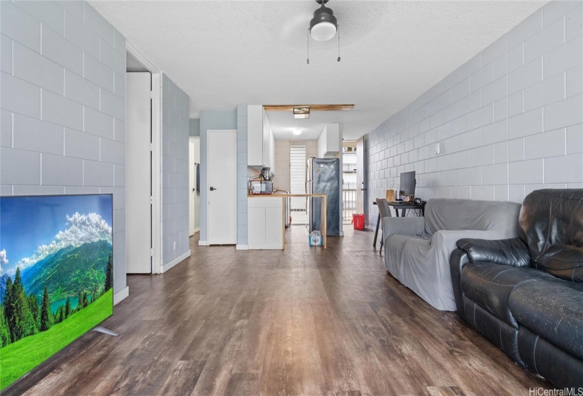 Big and bright space. Natural light and new floors. The living room, kitchen and entrance to the condo.