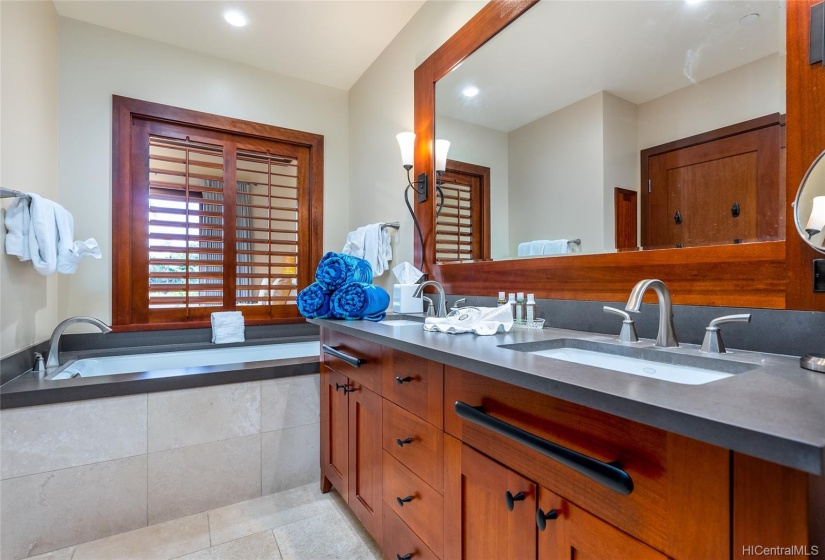 En suite master bathroom with deep soaking tub, separate shower, dual sinks and walk-in closet.