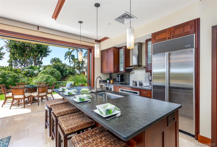 Flamed granite countertops accented by mahogany cabinets and trim and high-end stainless steel appliances.