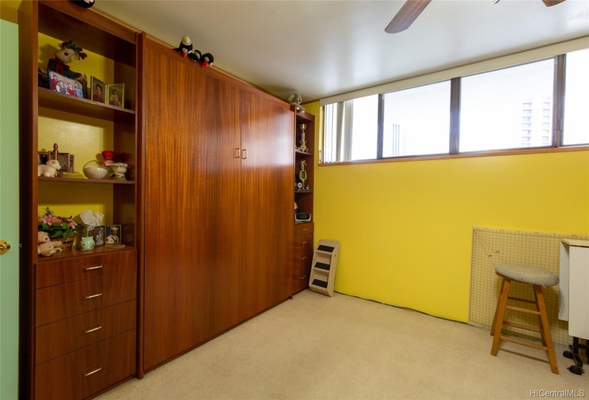 Murphy bed in up position. Guest room has ceiling fan.