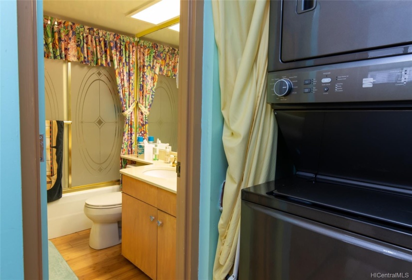 Large washer/dryer locked in hall just outside guest bathroom.