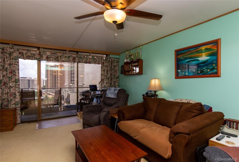 Living room with ceiling fan overhead.