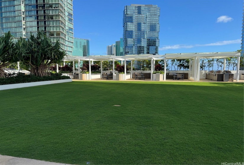 BBQ cabanas and open grass space.