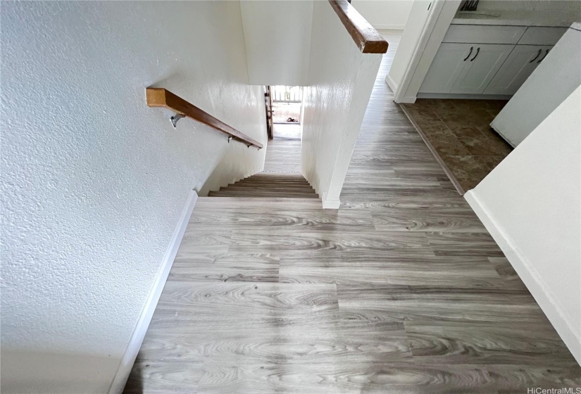 Hallway and Stairs with new laminate vinyl flooring.  LED lighting