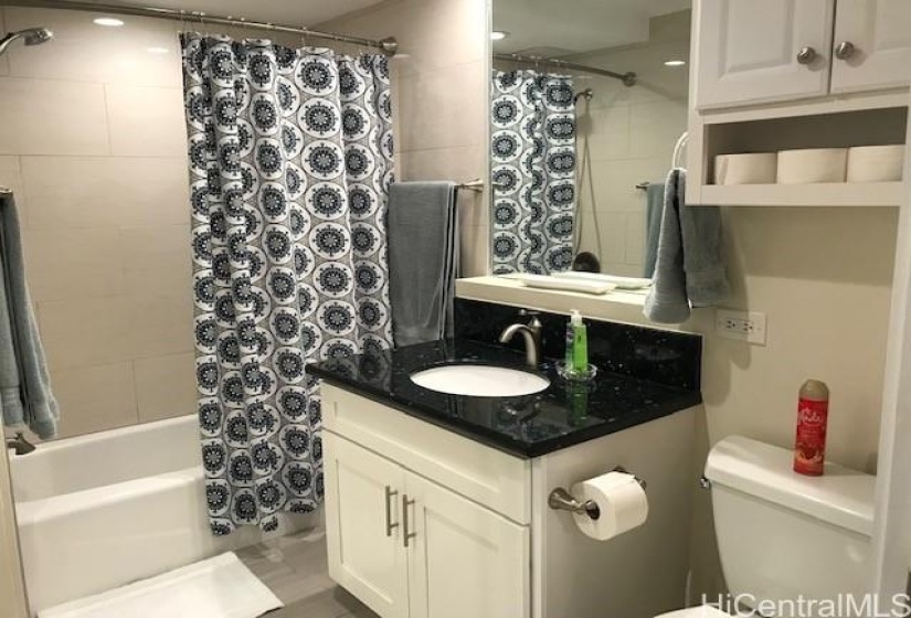 full bathroom with tub and storage