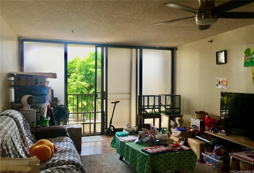 Living Area and efficient Lanai space looks to pleasant Tree Top Views.