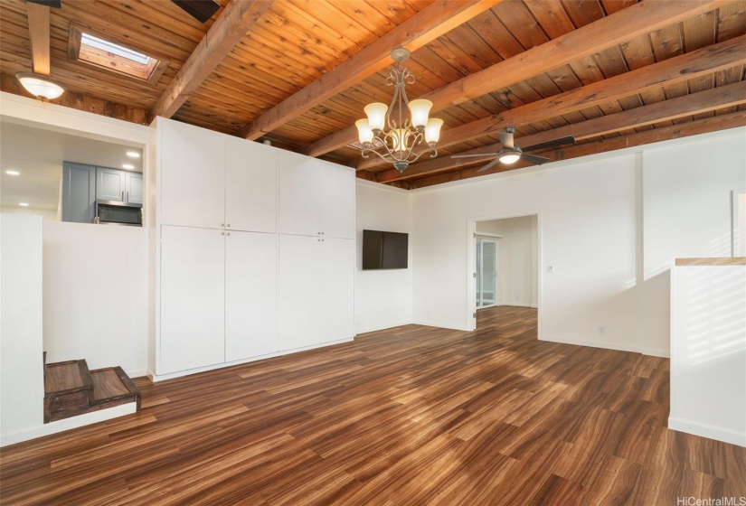 Lower level living room with copious storage and included wall-mounted TV.