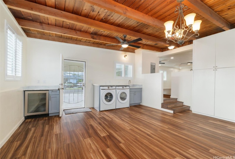 Lower level living room includes interior laundry, sink, and wine fridge.