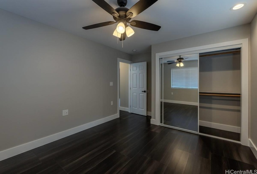 Bedroom #1 glass sliding closet doors.