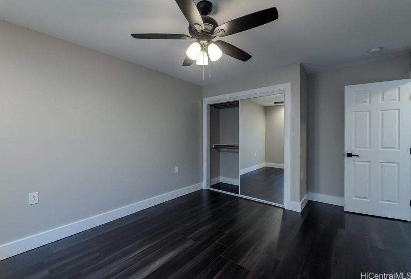 Bedroom #2 glass sliding closet doors.