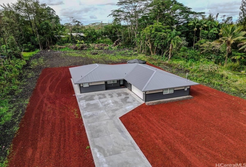 Aerial view of the entire property, landscaped with red cinder.