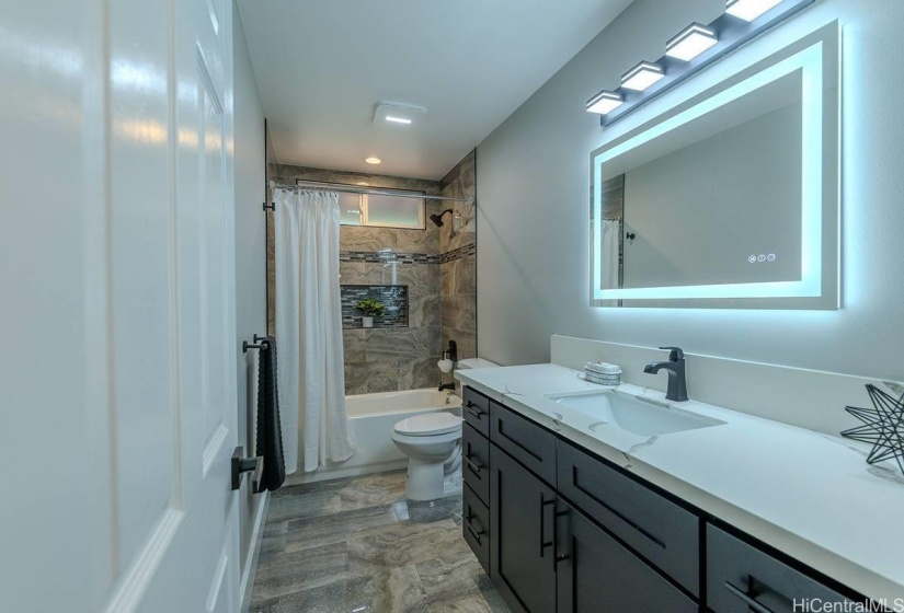 Hall bathroom with LED lighted mirror.