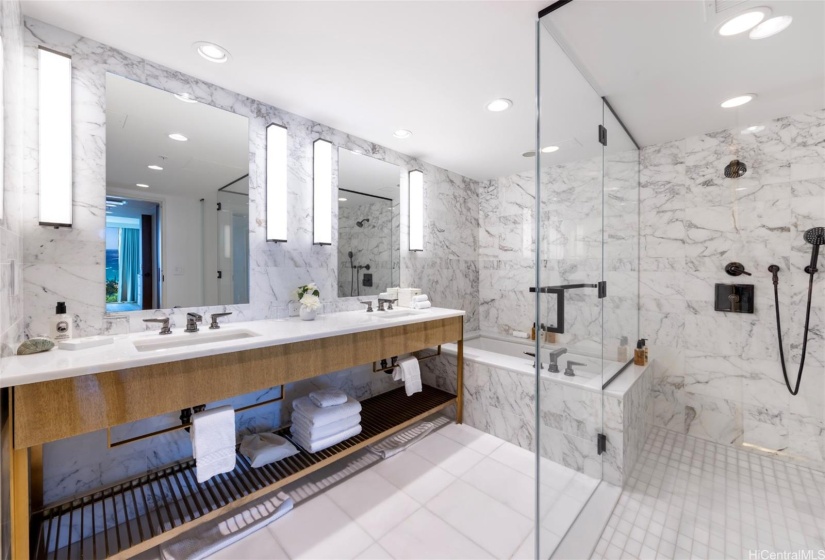 Ensuite primary bathroom with double vanity, deep soaking tub, and walk-in shower.