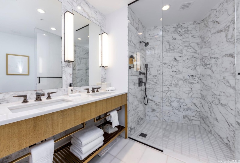 Second level full bathroom with double-vanity and walk-in shower.