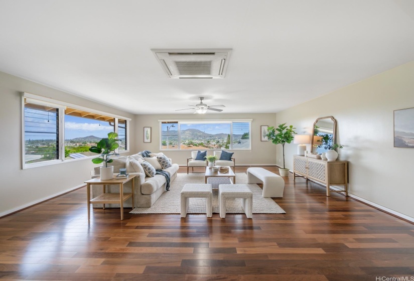 Living room with views of lake and mountains.