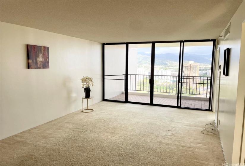 Very spacious living room that looks right out to an open lanai with city views and golf course views!