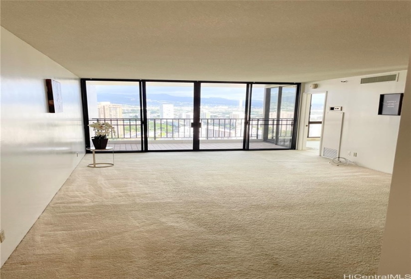 Another angle from the entry door to living room and on the right is the primary bedroom.