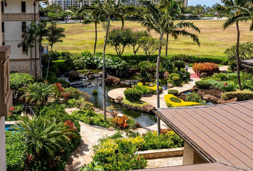 View across the koi ponds and manicured landscape to the water feature and pool areas.