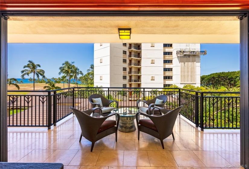 Views towards the ocean from either side of the Beach Tower. Large covered lanai with travertine tile flooring. Pocket lanai doors and automatic lanai shade.