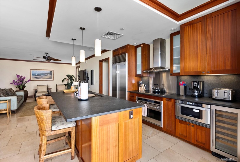 Beautiful open concept layout with freestanding island, flamed granite countertops, mahogany cabinets and trim, high end appliances (Sub Zero, Wolf, Sharp).