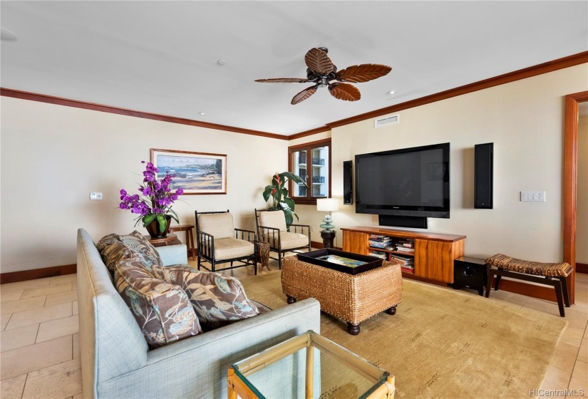 Comfortable seating in the living area with surround sound upgraded TV and lots of natural light and pass through breeze from the living room window across to the balcony lanai.