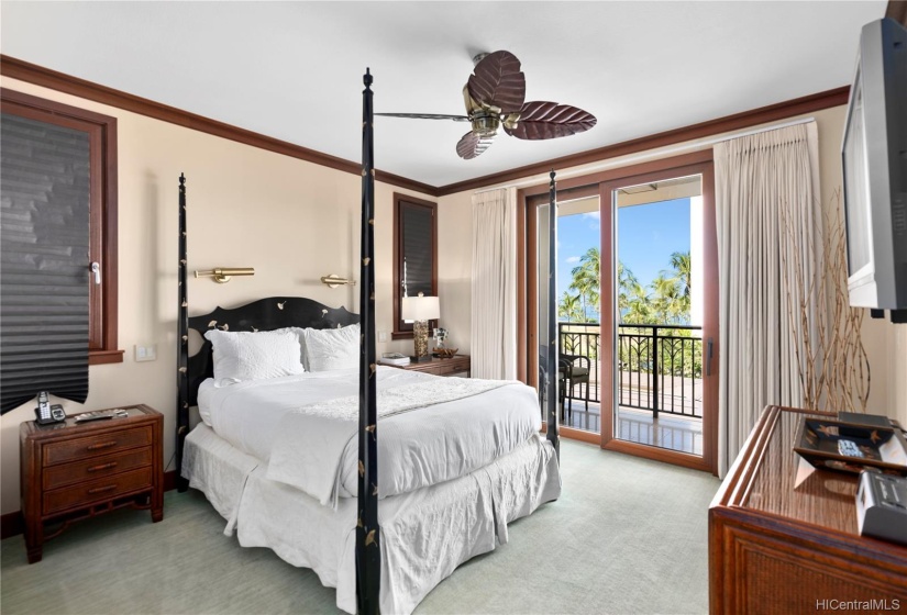 Luxurious and elegant master suite with direct access to the covered lanai. Central AC, ceiling fan, wall-mounted TV and en suite bathroom and walk in closet.