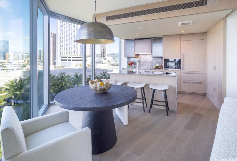 Dining to kitchen view with table and bar seats.