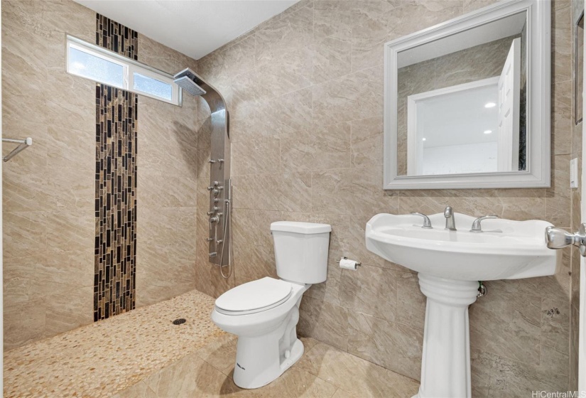 Master bathroom has ceramic tiles up to the ceiling.