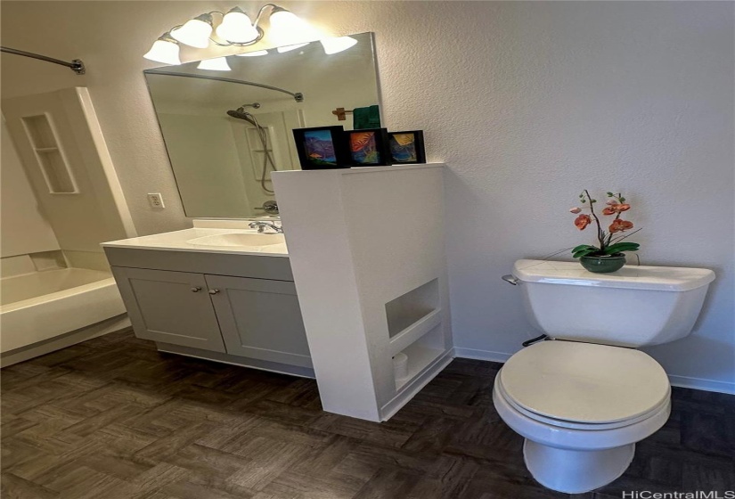 En-suite #2. Brightly lit bathroom with new Vinyl flooring and vanity.