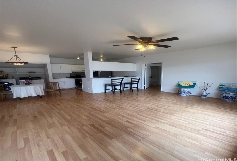 Living area with newly painted walls, and window AC.