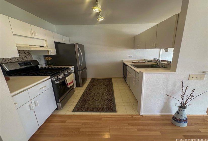 Kitchen. Ample cabinet space. Kitchen includes range/oven, refrigerator, and dishwasher.