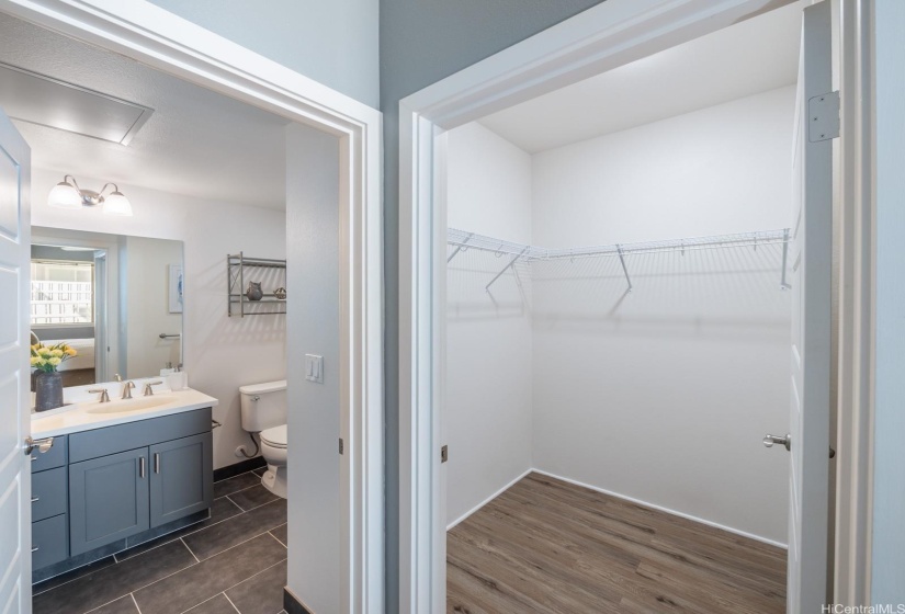 Walk in closet and en-suite bathroom in the primary bedroom