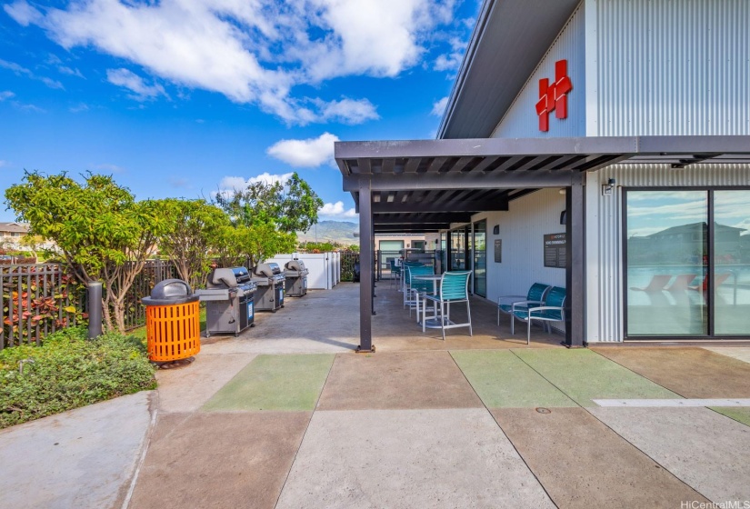 Covered area outside the club room with BBQs