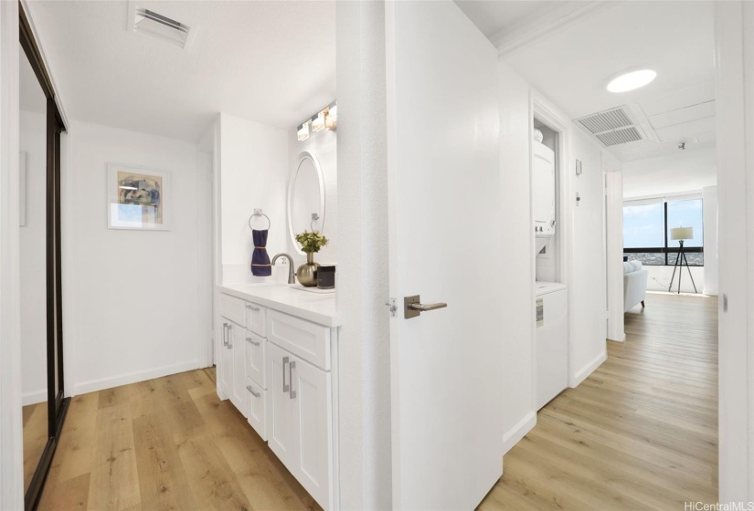 View to hallway washer/dryer and on the left, primary ensuite bathroom