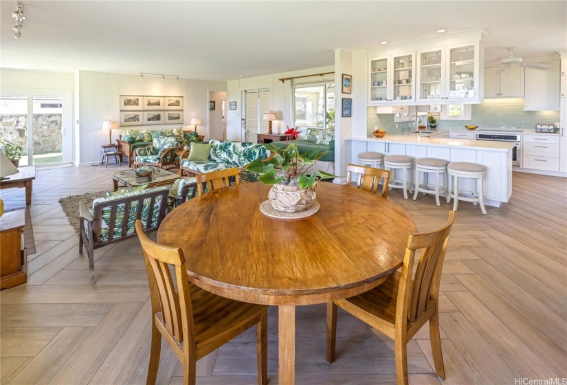 Kitchen with ample cupboard and counter space opens to living/dining area.