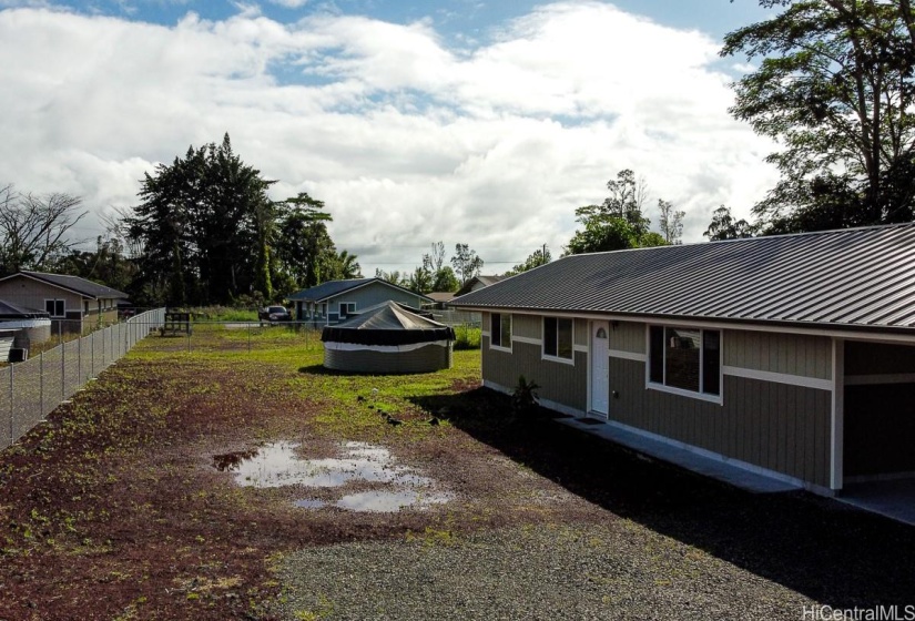 Long open space for play area, landscaping or hardscaping for storage and parking