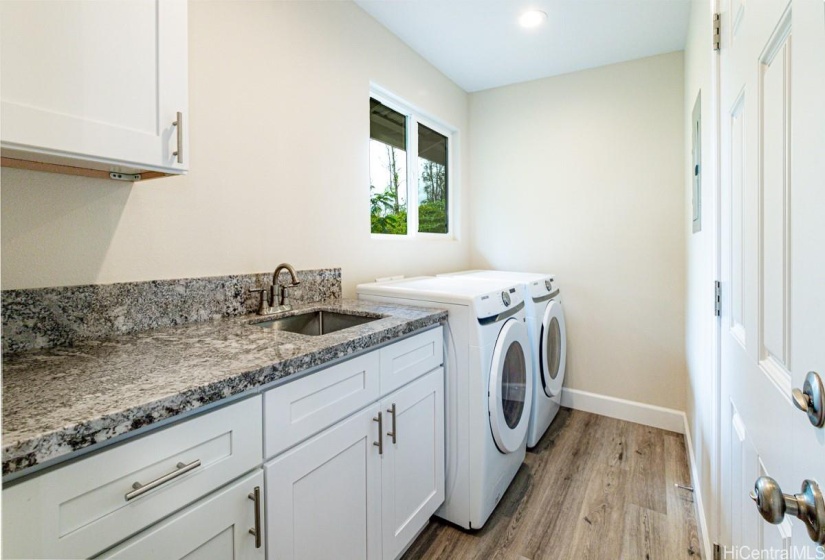 Indoor laundry room easy access to kitchen and carport