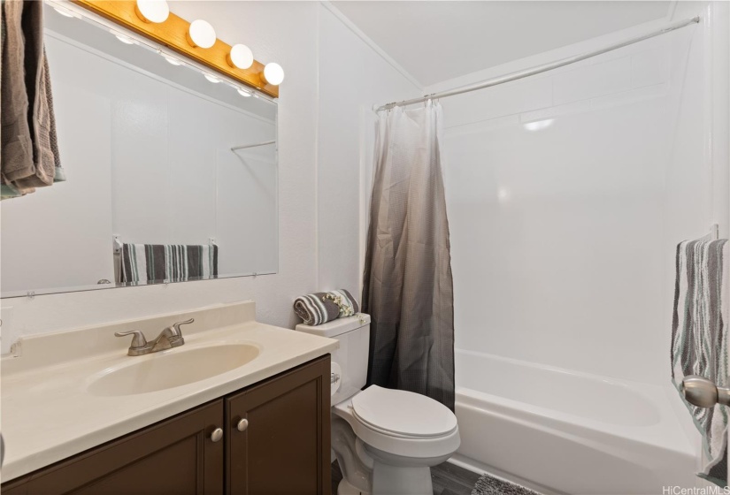 Perfect sized bathroom with newly reglazed bathtub and surround.