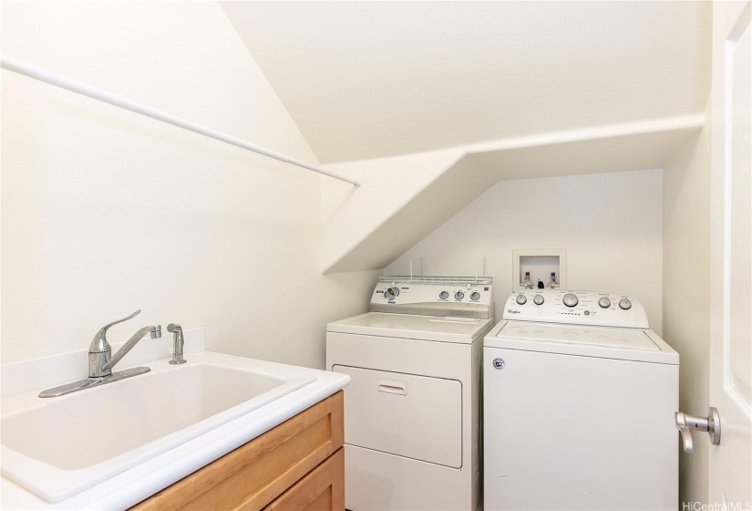 Dedicated laundry room downstairs to the left of hallway.