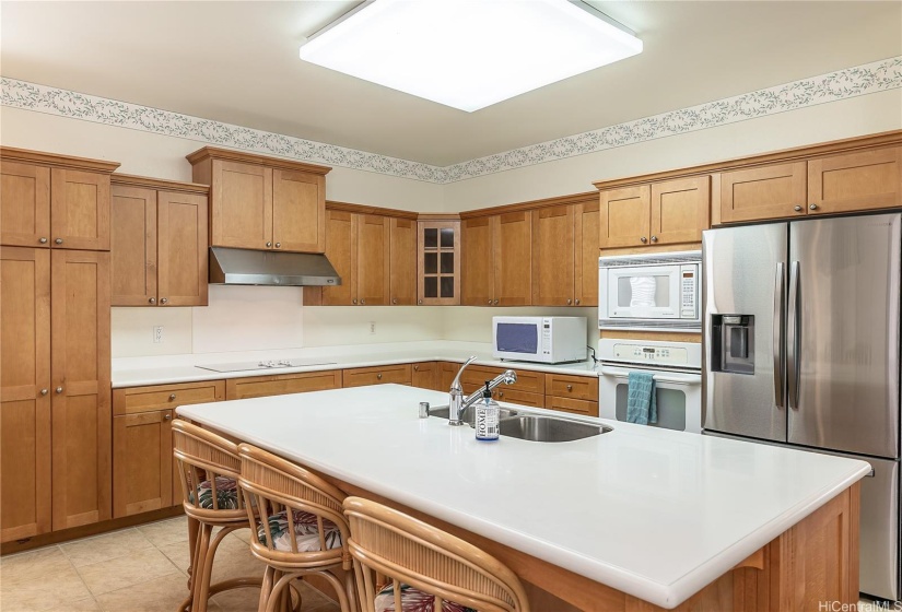 Kitchen view with new stainless steel refrigerator.